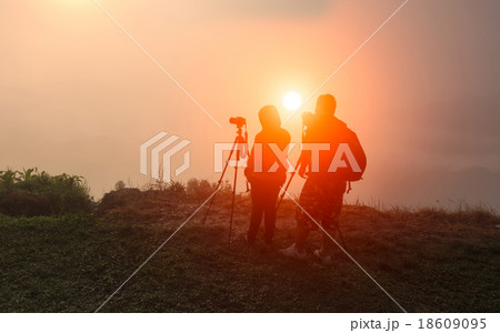 Nature photographer taking photos in the mountains 18609095