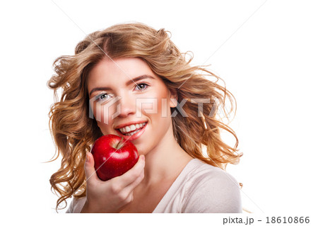 Girl with curly hair holding red apple and smiling Girl with curly hair holding red apple and smiling 18610866