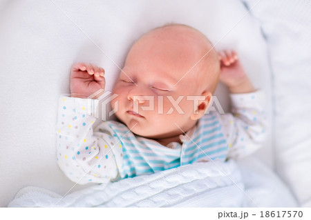 Cute newborn baby in white bed Cute newborn baby in white bed 18617570