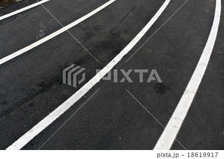 Running asphalt track with white painted lines. 18619917