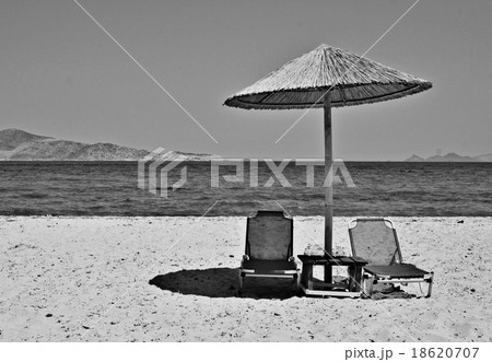 Greece. Kos island. Two chairs and umbrella  18620707