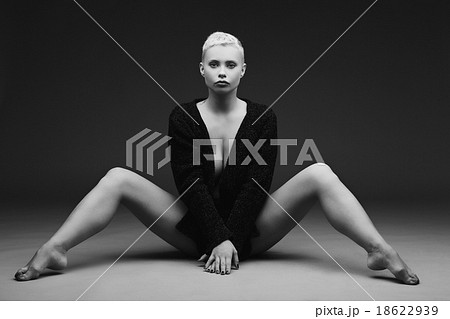 Beautiful young woman sitting with legs spread - Stock Photo 18622939