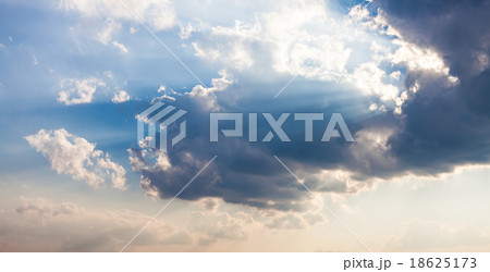 Beautiful blue sky with sunbeams and clouds 18625173