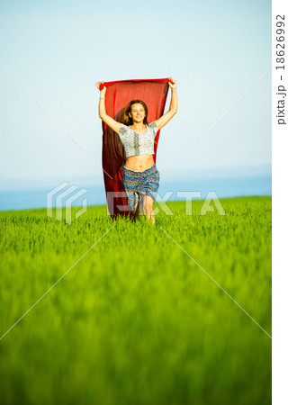 Young happy woman in wheat field with fabric Young happy woman in wheat field with fabric 18626992