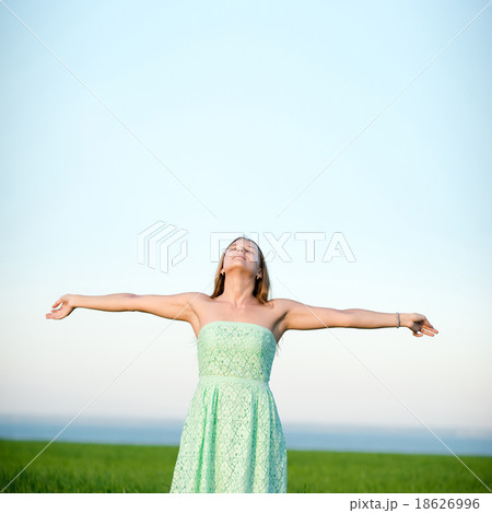 Happiness woman stay outdoor under sunlight of 18626996