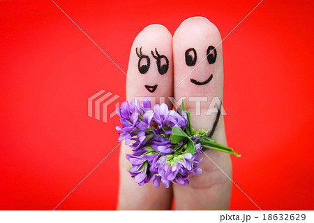 Face painted on fingers. Man is giving flowers  18632629