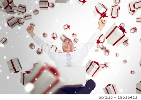 Composite image of successful businessman with laptop 18636413