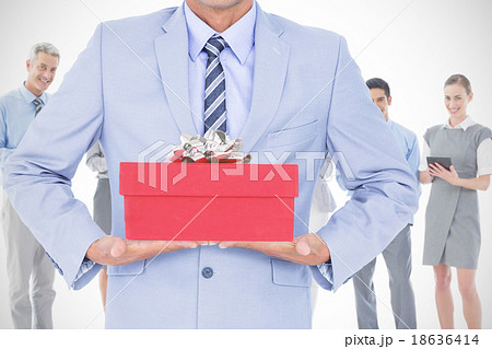 Composite image of businessman walking while gesturing with hand 18636414