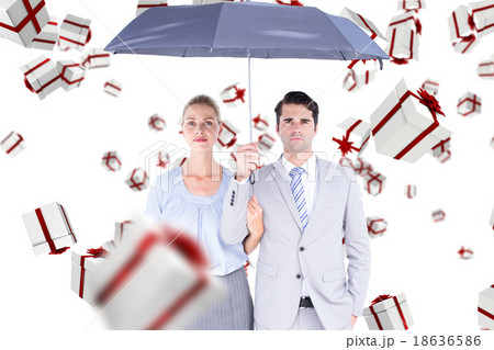 Composite image of business people holding a black umbrella 18636586