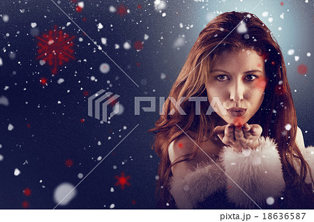 Composite image of festive redhead blowing a kiss 18636587