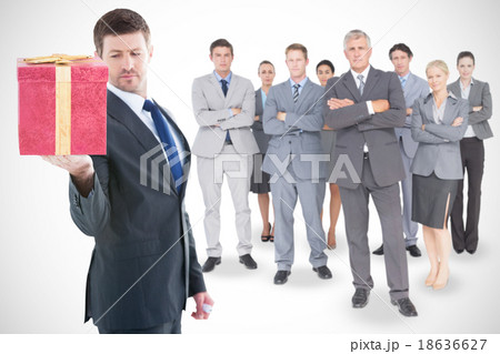 Composite image of businessman holding hand out in presentation Composite image of businessman holding hand out in presentation 18636627
