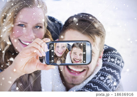 Composite image of hand holding smartphone showing 18636916