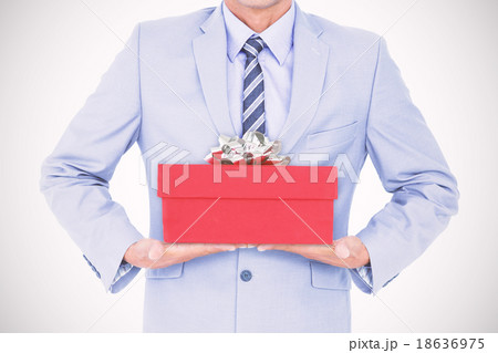 Composite image of businessman walking while gesturing with hand Composite image of businessman walking while gesturing with hand 18636975