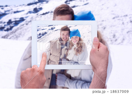Composite image of hand holding tablet pc Composite image of hand holding tablet pc 18637009