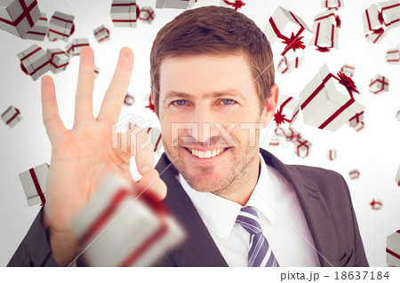 Composite image of businessman smiling and making ok sign Composite image of businessman smiling and making ok sign 18637184