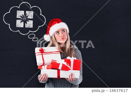 Composite image of festive blonde holding pile of gifts 18637617