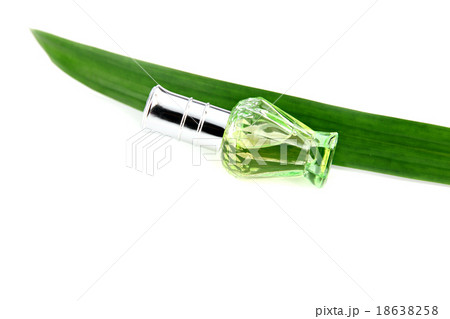 Green bottle of perfume and pandanus. 18638258
