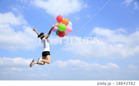 young woman jump with colorful balloons young woman jump with colorful balloons 18643562