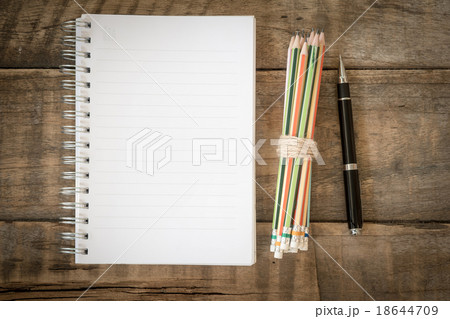 Notebook, pencil and pen on wooden table Notebook, pencil and pen on wooden table 18644709