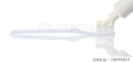 Toothpaste being squeezed onto toothbrush 18646924