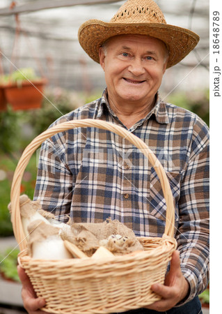 Skillful farm worker is carrying dairy products Skillful farm worker is carrying dairy products 18648789