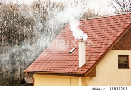 Red roof and smoking chimney 18651508
