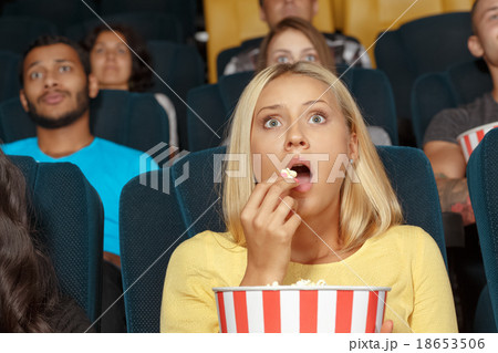 Young girl watching a movie with admiration 18653506