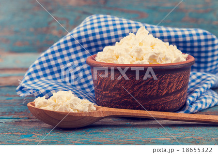 Fresh cottage cheese in a ceramic dish and spoon 18655322