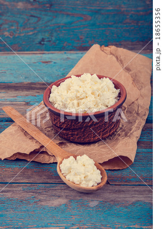 Fresh cottage cheese in a ceramic dish and spoon 18655356
