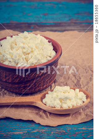 Fresh cottage cheese in a ceramic dish and spoon 18655360