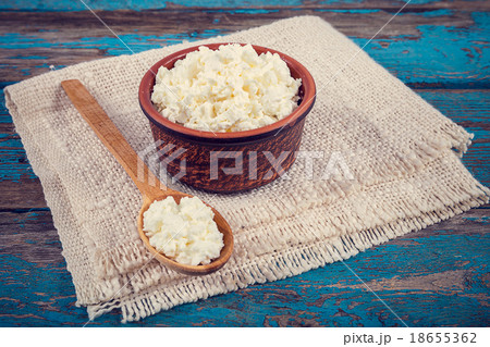 Fresh cottage cheese in a ceramic dish and spoon 18655362