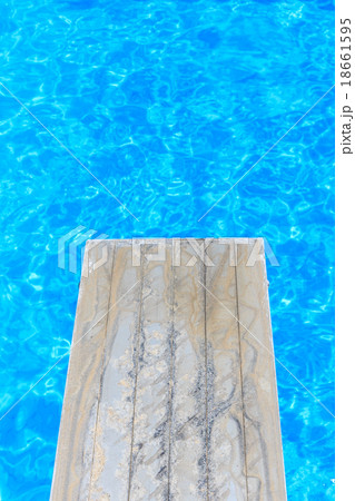 Swimming pool with old wooden diving board Swimming pool with old wooden diving board 18661595