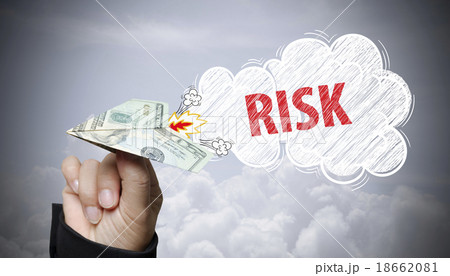 hand holding dollar plane with risk text 18662081
