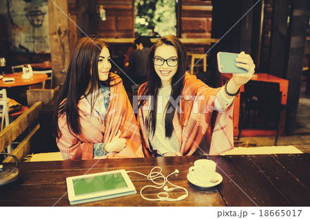 two close friends make selfie in the cafe 18665017