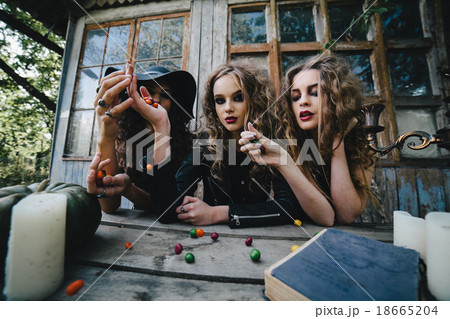 Three vintage witches perform magic ritual 18665204