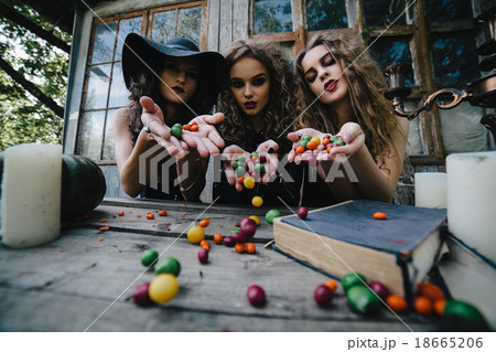 Three vintage witches perform magic ritual 18665206