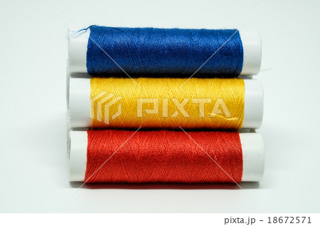 Three spools of threads, blue, yellow, red Three spools of threads, blue, yellow, red 18672571