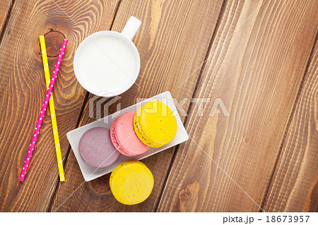 Colorful macaron cookies and cup of milk 18673957