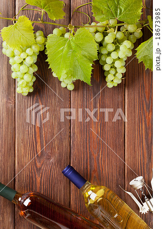 Bunch of grapes, white wine bottles and corkscrew 18673985