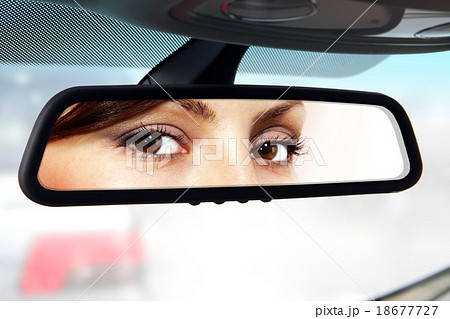 driver looks to rear-view mirror driver looks to rear-view mirror 18677727