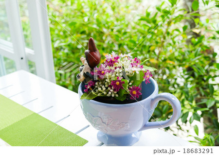 fake purple flower in blue ceramic cup 18683291