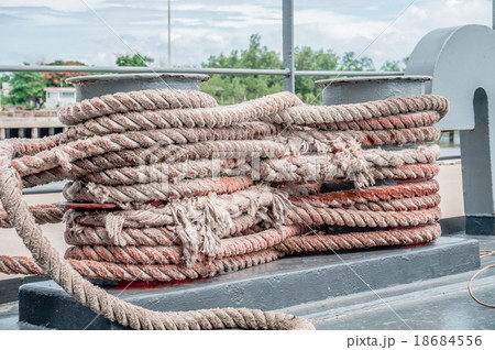 old rope tied with a ship cleat in port old rope tied with a ship cleat in port 18684556