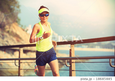 fitness woman running on wooden boardwalk seaside fitness woman running on wooden boardwalk seaside 18685885