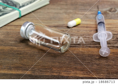 Medical Syringes, Vial  And Wad Of Cash Close-up 18686713