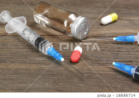 Medicine Vials, Syringe And Drugs On Wood Table 18686714