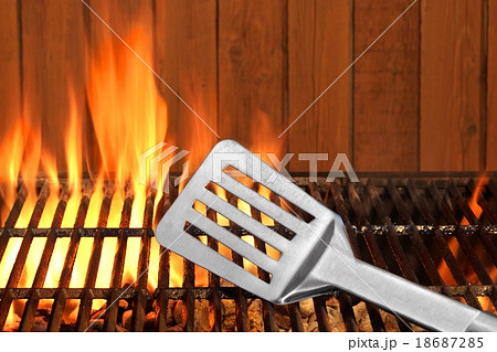 Spatula Close-up On The Hot Flaming BBQ Grill Spatula Close-up On The Hot Flaming BBQ Grill 18687285