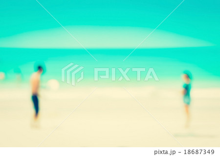Blur image of two people playing at the beach  18687349