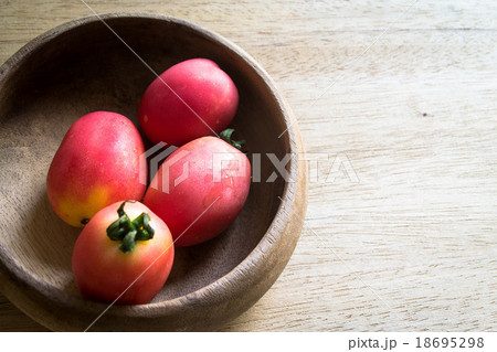 tomatoes in  wooden bowl 18695298