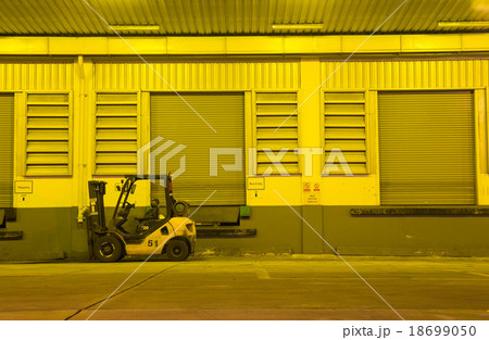 Warehouse with yellow lights at night 18699050