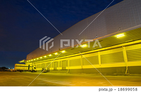 Warehouse with yellow lights at night 18699058